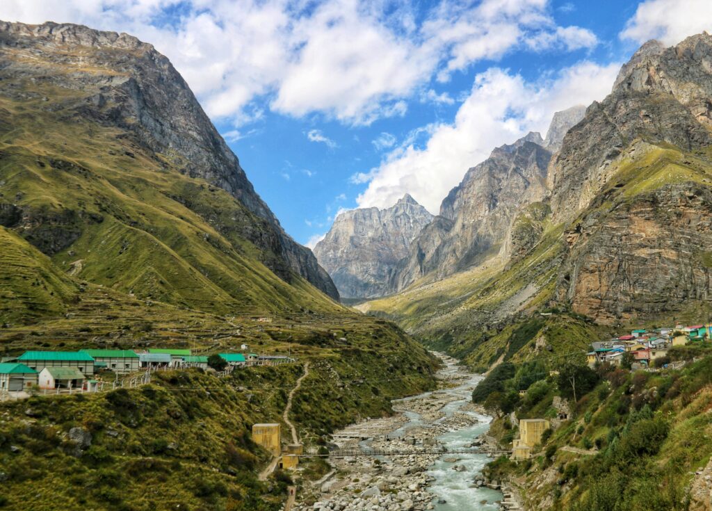 Explore the breathtaking beauty of Mana village nestled in the Himalayas with its stunning mountains and river.