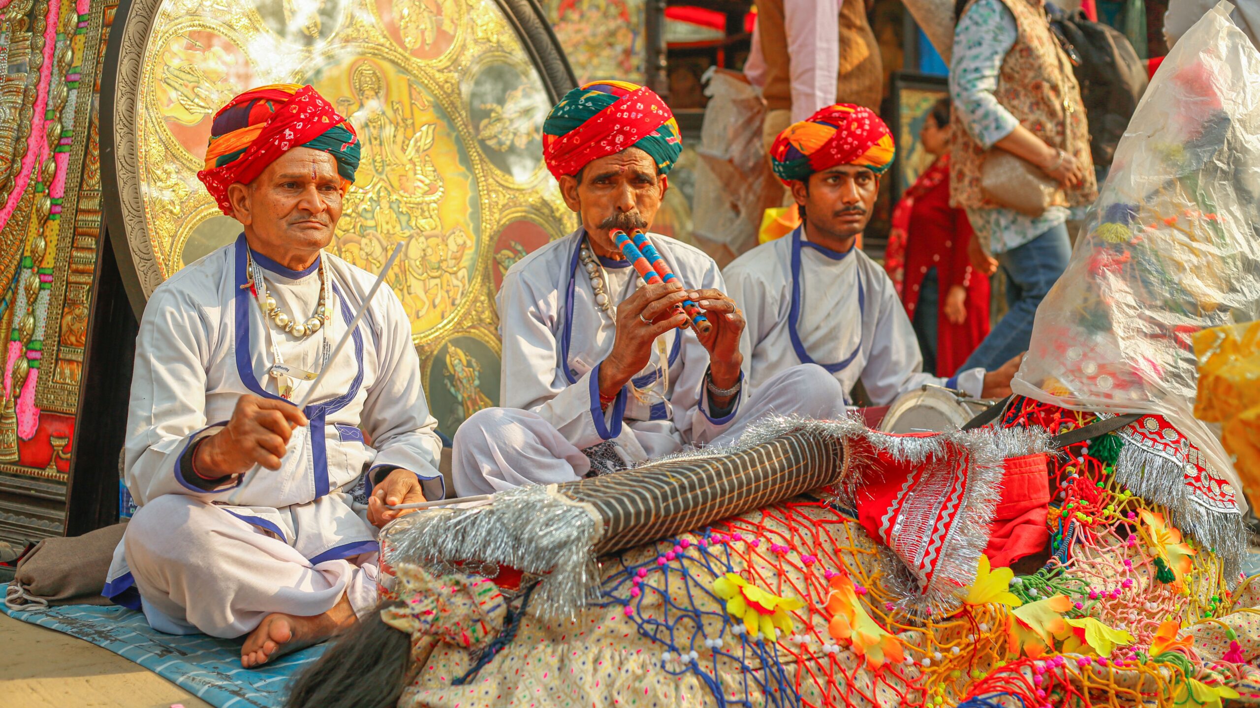 Versatility of Culture & Places to Experience in India Indian men in traditional clothing playing musical instruments at a cultural festival.